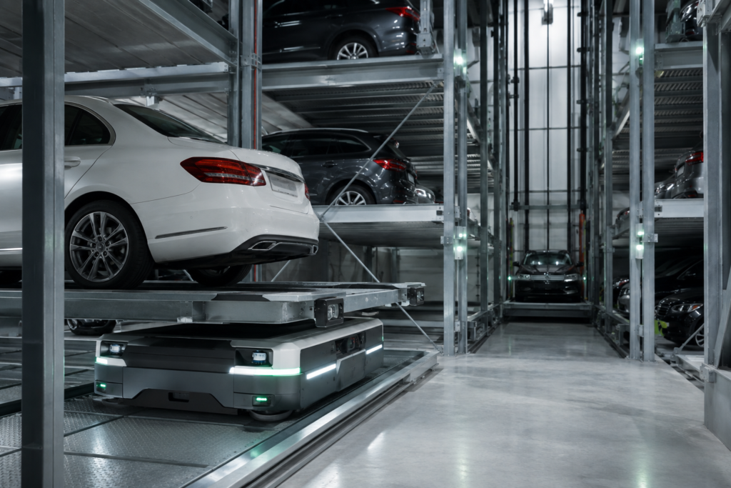 Palletless robotic shuttle moving a car inside an automated parking structure